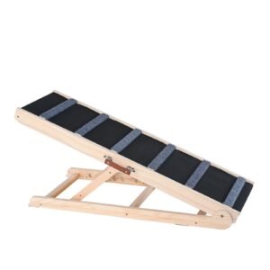 Solid wood folding dog ramp leaning against a bed with non-slip traction carpet